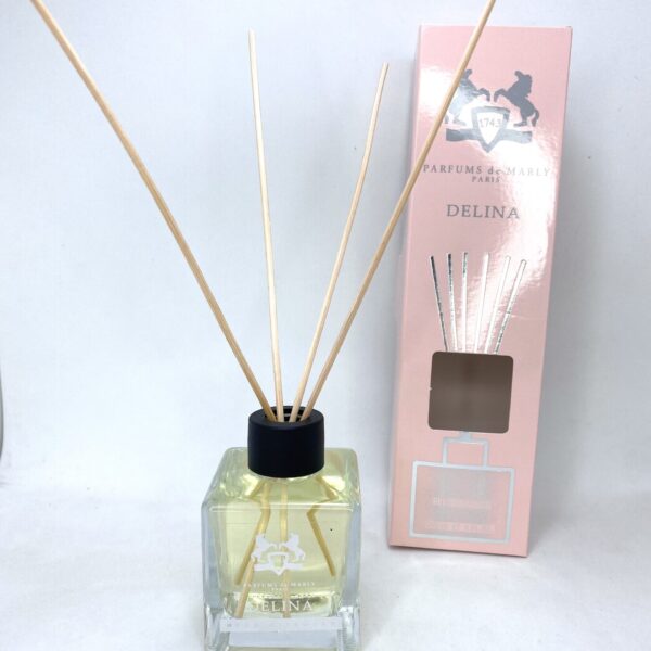 Reed diffuser with Delina fragrance in a glass bottle, ideal for home scenting.