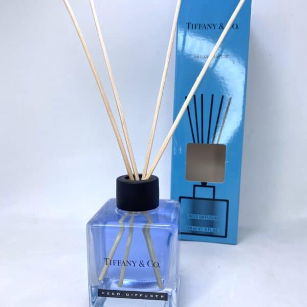 Elegant Tiffany & Co reed diffuser with blue glass bottle and natural reeds.